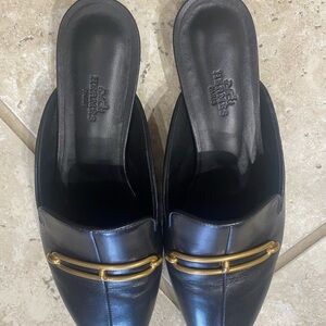 Hermes Black Leather Slip-On Mules with Gold Accent.